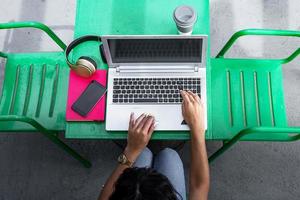 Crop freelancer browsing data on laptop photo