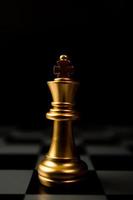 Golden Chess King standing alone on the chessboard photo