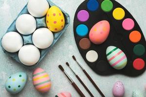 Happy Easter. Colored easter painted eggs with watercolors and brushes photo