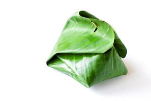 Sweet sticky rice with Thai custard in the banana leaf wrapped photo