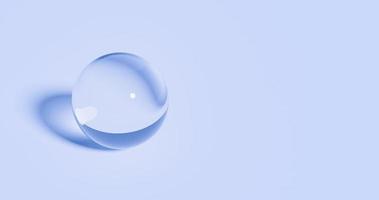 Clear glass ball shape on soft blue background photo