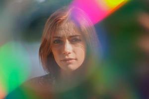 funky portrait of a young woman with lens flare and light leaks photo