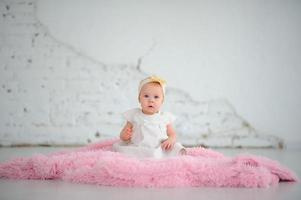 Little cute girl learns to crawl. photo