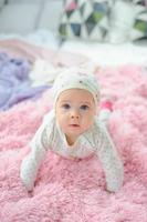 Little cute girl learns to crawl. photo