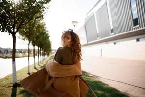 Autumn portrait of a red-haired girl on the street photo