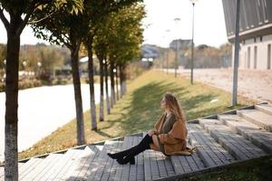 Autumn portrait of a red-haired girl on the street photo