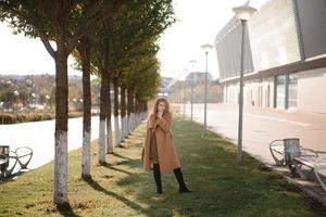 Autumn portrait of a red-haired girl on the street photo