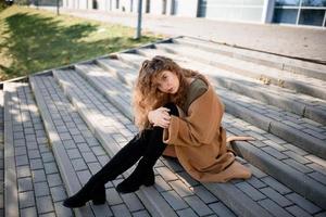 Autumn portrait of a red-haired girl on the street photo