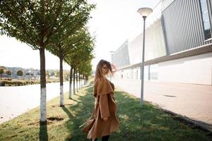 Autumn portrait of a red-haired girl on the street photo