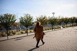 Autumn portrait of a red-haired girl on the street photo