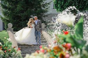 The bride and groom hold each other's hands. A man and a woman look into each other's eyes. photo