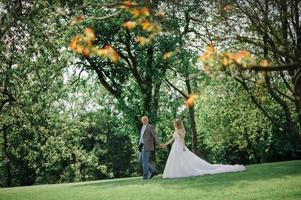 The bride and groom hold each other's hands. A man and a woman look into each other's eyes. photo