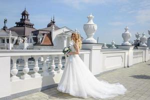 Portrait of a beautiful blonde bride with a bouquet. photo