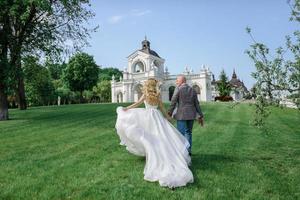 The bride and groom hold each other's hands. A man and a woman look into each other's eyes. photo