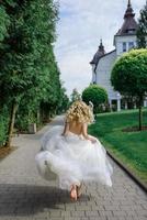 Portrait of a beautiful blonde bride. A woman runs away from her wedding. photo
