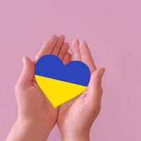 love blue and yellow heart in hands on colorful background.  Ukraine concept photo