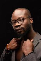 A black African American is emotionally singing into a microphone. Close-up studio portrait. photo