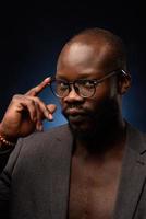 A black African American is emotionally singing into a microphone. Close-up studio portrait. photo