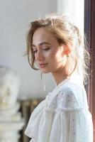 Close-up portrait of a young beautiful woman. The women looks into the frame. photo