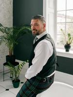 handsome mature courageous  stylish scotsman businessman in kilt and suit in bathroom. Style, work from home, fashion, lifestyle, culture, ethnic concept. photo