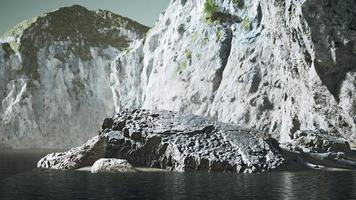 stone cliffs and broun sand at the ocean coastline photo