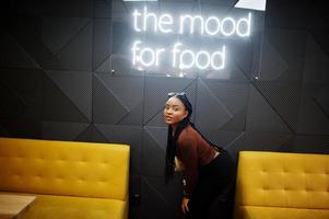 In the mood for food. African woman in cafe. photo