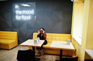 In the mood for food. African woman in cafe. photo