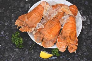 Flathead lobster shrimps served on white plate, Fresh slipper lobster flathead boiled cooking with parsley photo