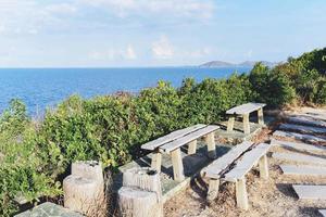 Bench on top hill for viewpoint the sea with tree - mountains view with sea in the thailand photo