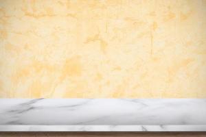 White marble table with old concrete textured wall background. photo