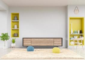 mueble tv en salón moderno con estante amarillo, mesa, flor, silla y planta sobre fondo de pared blanca.