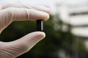 Forensic officers holds physical evidence which is the bullet shell up to eye level to determine the size and type of ammunition at the murder. photo