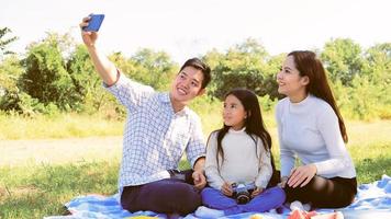 Asian caucasian family taking selfie with parents father mother daughter in  vacation to smiles in gerden so joyful feeling with family of holiday togetherness joy relationship lifestyle asians people photo