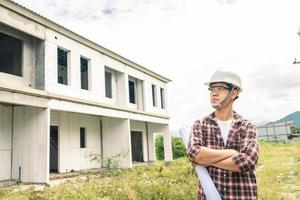 Young asian checking house with foreman engineering home inspection building house Walk home inspection with looking and pointing construction for check building home on job site to construction 2021 photo