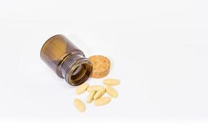 Vitamin C pills out of brown bottle photo
