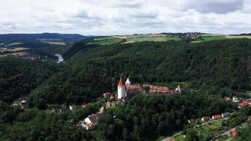 Aerial view of old castle in village - orbiting