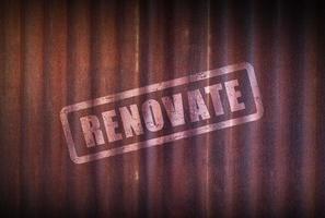 Renovation sign on old zinc sheet rust background. photo