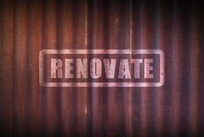 Renovation sign on old zinc sheet rust background. photo