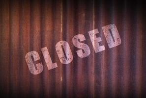 Closed sign on old zinc sheet rust background. photo