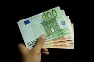 Male hand holding euro money banknotes photo