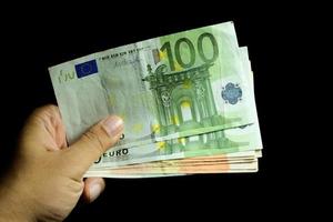 Male hand holding euro money banknotes photo