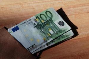 Euro banknotes in salary brown envelope. photo