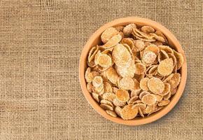 flakes in a bowl on burlap background, food closeup photo