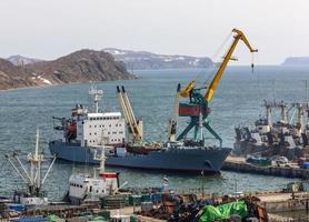 Panorama on ships at pier, port cranes on commercial seaport Petropavlovsk-Kamchatsky photo