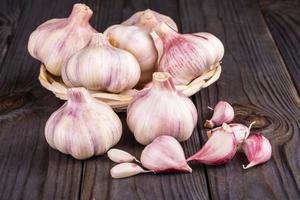 Cloves of garlic on wooden background photo