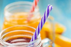 Fresh pineapple and strawberry smoothie in glasses with fruits photo