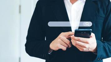 man's hand use smartphone to find things that interest you. Finding information about internet networking concepts. photo