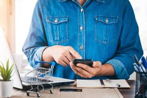 businessman using smartphone paying and shopping with smartphone application, online payment, banking and online shopping at the office, Digital money transfer, banking and e commerce concept. photo