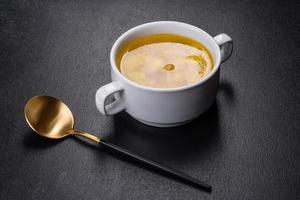 Fresh pea soup in bowl on black background. Cooking at home photo