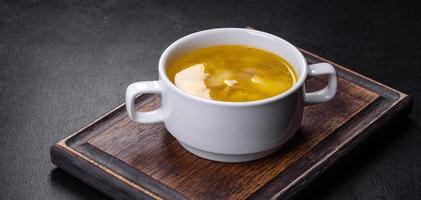 Fresh pea soup in bowl on black background. Cooking at home photo